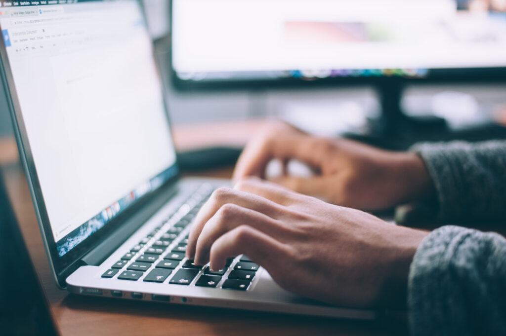 Business owner types on a laptop